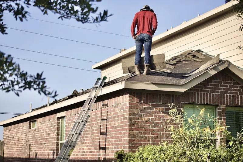 Professional roofer working on a residential roof in Wheaton Forest
